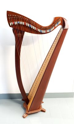 a large wooden harp sitting on a stand in a room