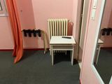 a small table and chair in the corner of a room