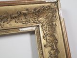 a picture of a gold picture frame with a flower design on it