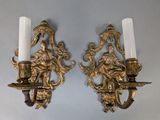 pair of antique brass wall sconces with figures and candles