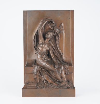 a bronze sculpture of a woman sitting on a bench