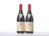 two bottles of red wine sitting on top of a white table