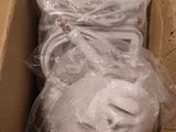 a cardboard box filled with white items and wrapped in plastic