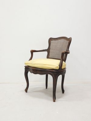 an image of a chair with a yellow cushion on it