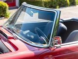 a close up of a red convertible car with the top down