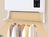 an air conditioner mounted on a wall with clothes hanging on it