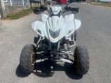 an image of a white quad bike parked on the side of the road