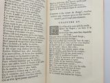an open book with a black and white image of a man ' s hand holding a book
