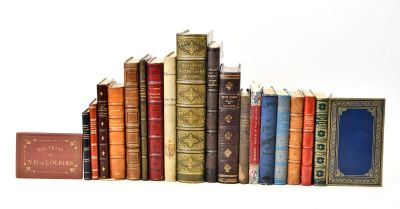 many old books lined up on a white surface