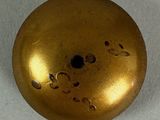 gold colored metal ball with holes and holes in the center