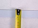 a measuring tape attached to a wall next to a wall
