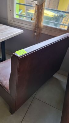 a small table and a bench in the corner of a room