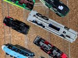 many toy trains on display in a clear display case