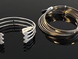 two bang bracelets and a bracelet with diamonds on a black surface