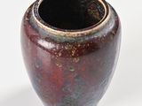 a vase that is sitting on a white surface