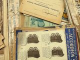 a pile of old newspapers and old papers on a table