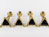 three pairs of gold and black stone earrings on a white background