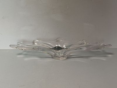 a glass bowl with a bird on it on a table