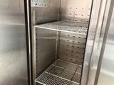 a stainless steel refrigerator that is open and empty