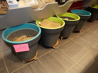 many buckets of dirt in a row on the floor