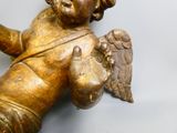 a gold statue of an angel holding a bird