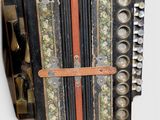 a close up of an old accordion on a white surface