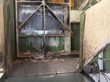 a green truck that is parked in a garage