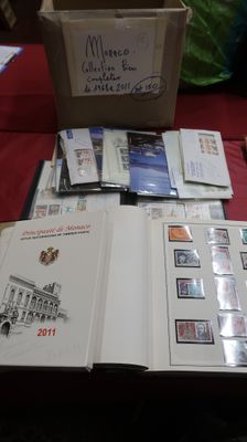 a lot of stamps on a table with a box of them