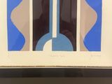 framed picture of a blue and white abstract painting on a wall