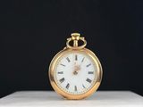 une vieille montre de poche en or avec des chiffres romains sur le cadran