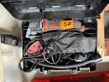 a tool in a case that is sitting on the floor