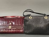 two purses are lined up on a table with a gray background