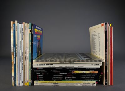 many books stacked on top of each other on a table