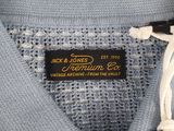 the label on a blue shirt is attached to a white cord