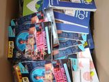 a cardboard box full of books and dvds in it
