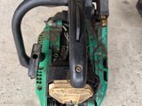 a chainsaw sitting on the ground next to a chainsaw