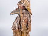 wooden statue of a man with a hat and a book