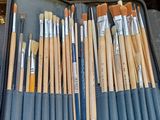 many brushes and brushes in a case on a table