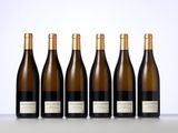 six bottles of wine lined up in a row on a table