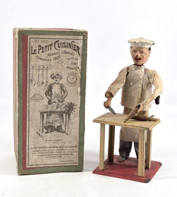 a figurine of a man with a knife in front of a box