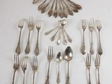 many forks and spoons laid out on the table