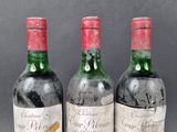 three bottles of wine sitting on top of a table next to each other