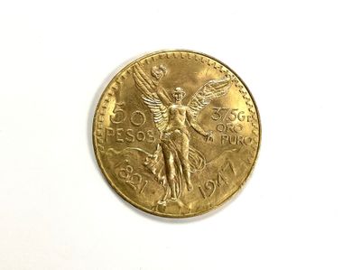 a gold coin with an angel on it on a white surface