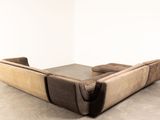a picture of a couch that is sitting on a concrete floor