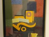 tableau encadré représentant un camion jaune et une tasse jaune posés sur une table