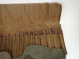 a roll up tool bag with a bunch of screws in it