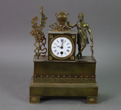 une horloge en bronze surmontée d'une statue
