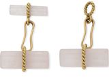 une paire de boucles d'oreilles avec une cordelette et une pierre rose