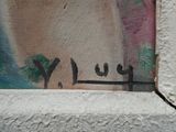 graffiti on the wall of a building that has a window with a window sill