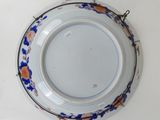 a white plate with blue and orange flowers on it